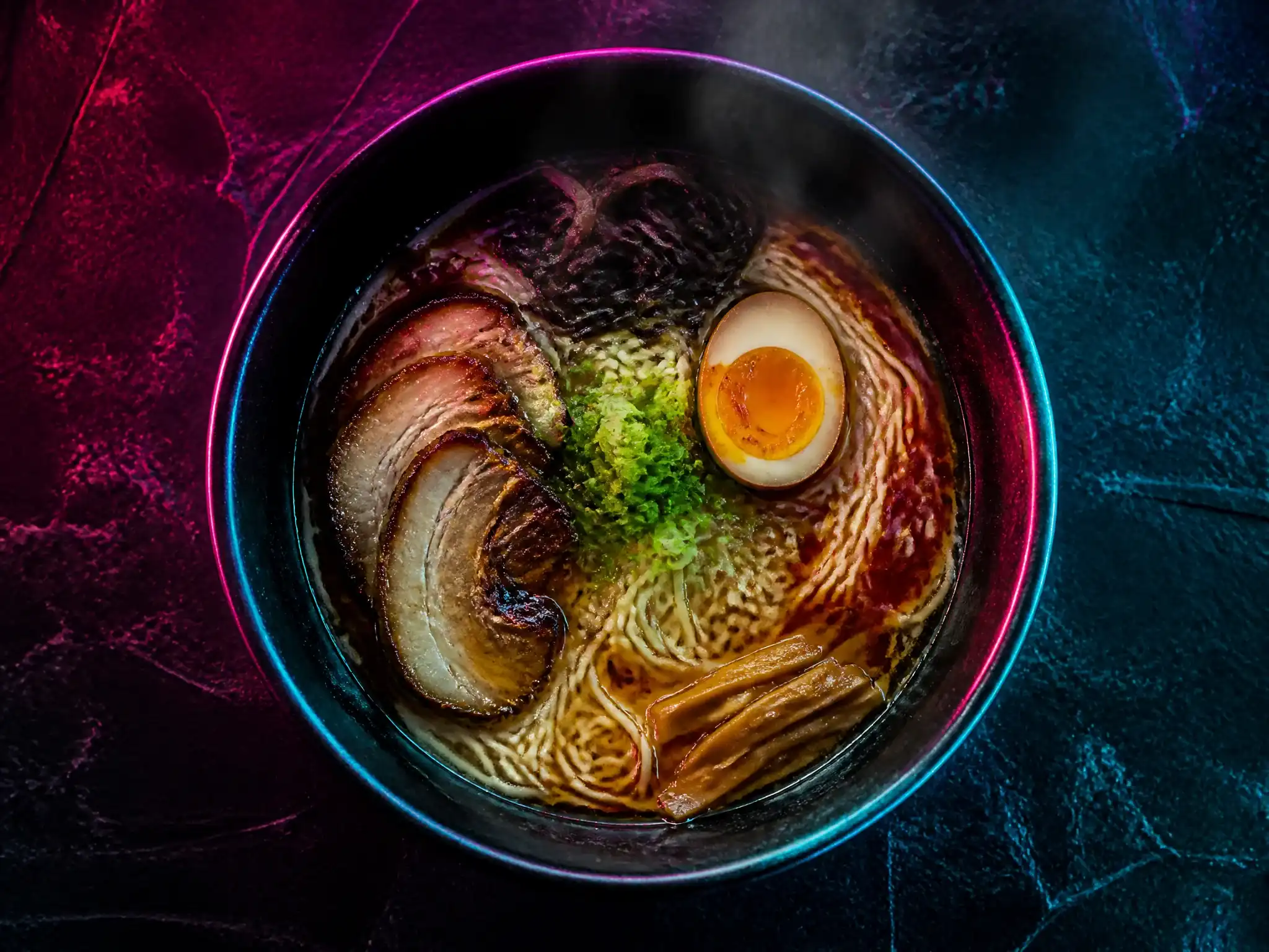 Signature ramen bowl under neon pink and teal light