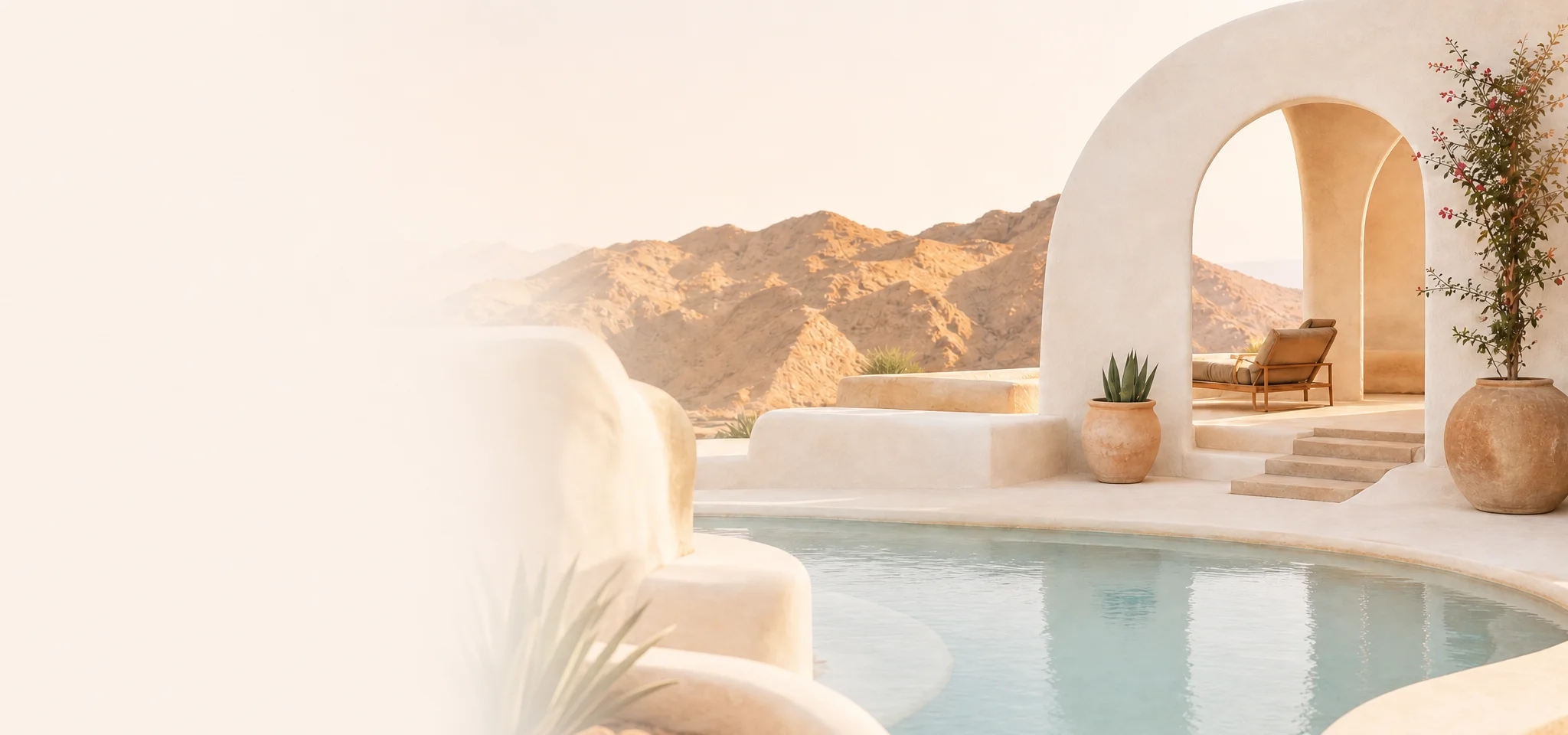 Sunlit desert spa with arched adobe architecture, plunge pool, and mountains